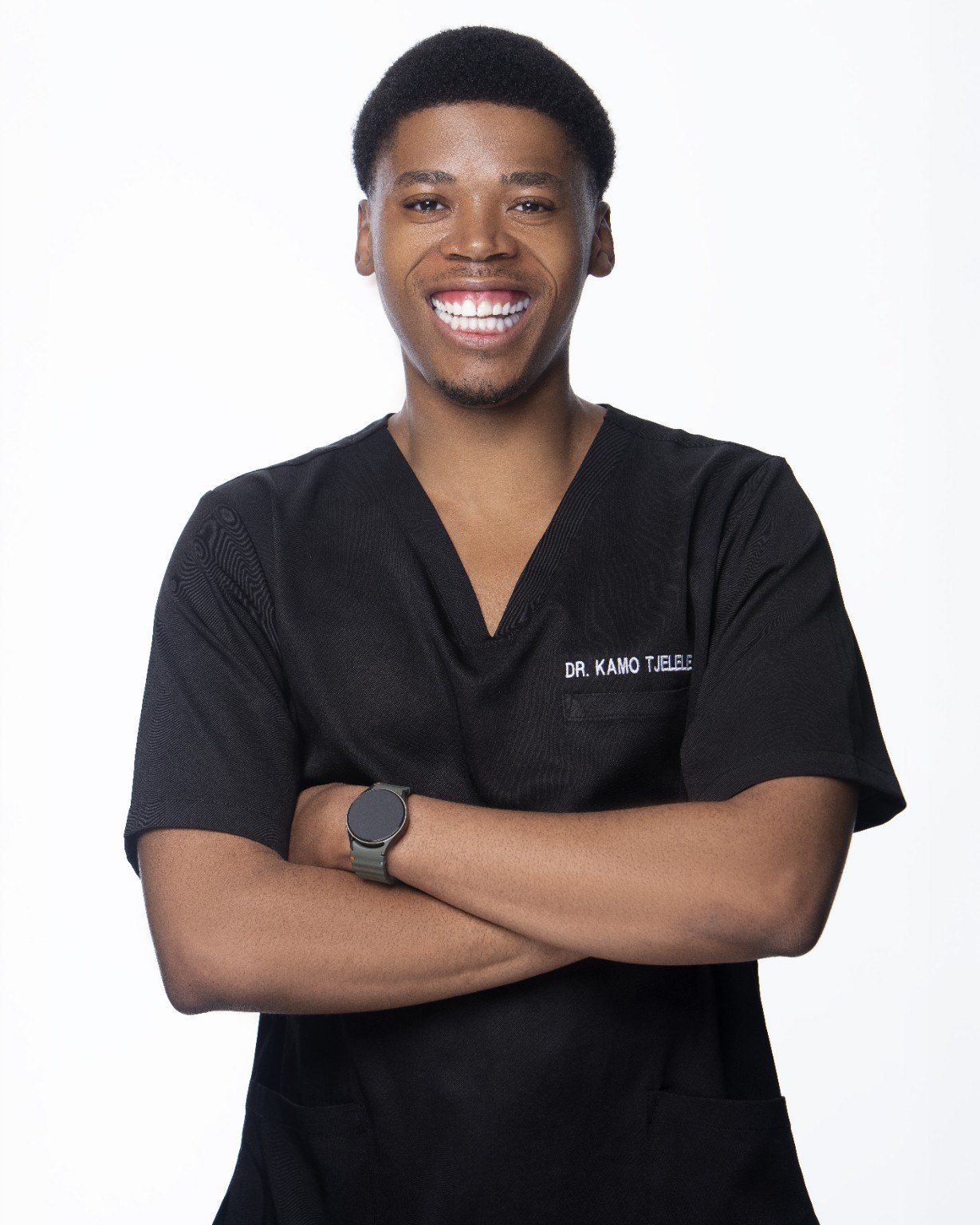 Dr. Kamo Tjelele wearing medical scrubs